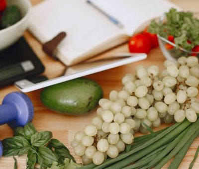 A vibrant composition of fruits, vegetables, and fitness items promoting a healthy lifestyle.